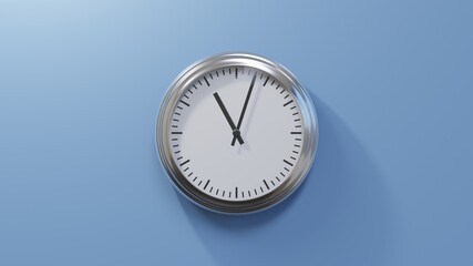 Glossy chrome clock on a blue wall at three past eleven. Time is 11:03 or 23:03