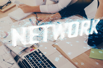 Double exposure of woman's writing hand on background with data technology hud. Big data concept.