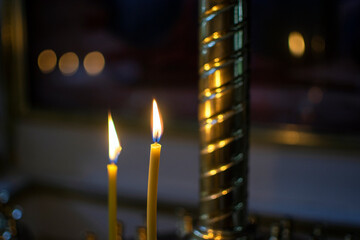 Burning candle in the church. close-up.