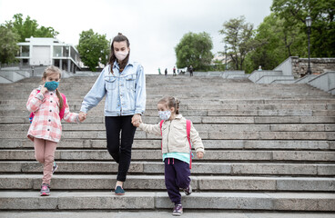 Back to school . Coronavirus pandemic children go to school in masks