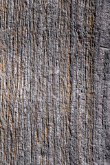 Grau brauner hell dunkler altes Fels mit farbigen vertikalen Parallelen Linien