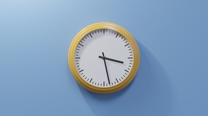 Glossy orange clock on a blue wall at twenty-eight past three. Time is 03:28 or 15:28