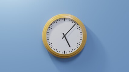 Glossy orange clock on a blue wall at seven past five. Time is 05:07 or 17:07