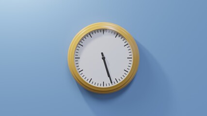 Glossy orange clock on a blue wall at twenty-seven past five. Time is 05:27 or 17:27