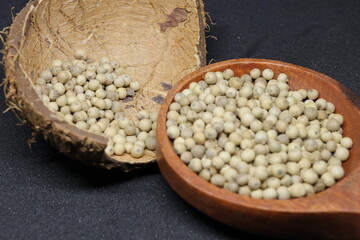 White pepper grains isolated on black background