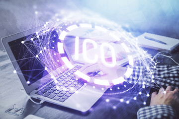 Blockchain theme hologram with man working on computer on background. Concept of crypto chain....