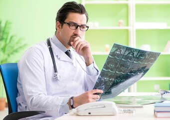 Doctor radiologist looking at x-ray scan in hospital