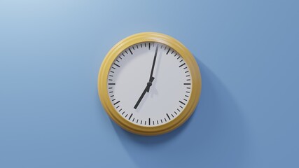 Glossy orange clock on a blue wall at two past seven. Time is 07:02 or 19:02