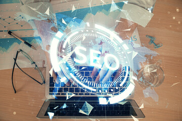 Double exposure of seo icon with man working on computer on background. Concept of search engine optimization.