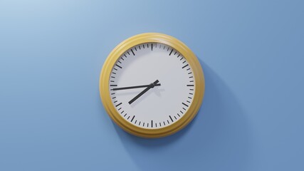 Glossy orange clock on a blue wall at forty-four past seven. Time is 07:44 or 19:44