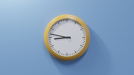 Glossy orange clock on a blue wall at forty-seven past eight. Time is 08:47 or 20:47