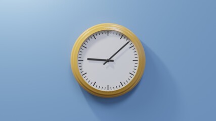 Glossy orange clock on a blue wall at eight past nine. Time is 09:08 or 21:08