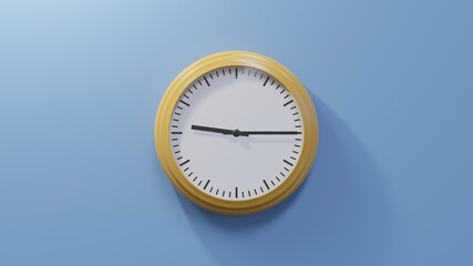 Fototapeta na wymiar Glossy orange clock on a blue wall at quarter past nine. Time is 09:15 or 21:15