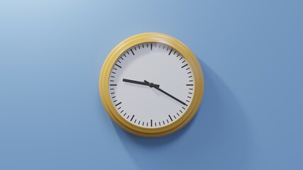 Glossy orange clock on a blue wall at twenty past nine. Time is 09:20 or 21:20