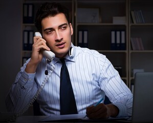 Call center operator talking to customer during night shift