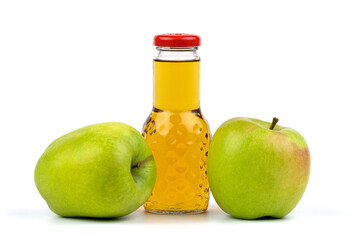 Apple juice bottle. Nearby are juicy, beautiful apples.