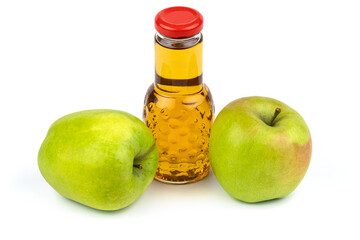 Apple juice bottle. Nearby are juicy, beautiful apples.