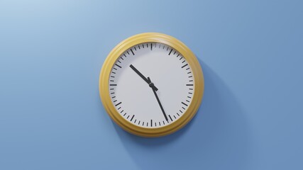 Glossy orange clock on a blue wall at twenty-six past ten. Time is 10:26 or 22:26