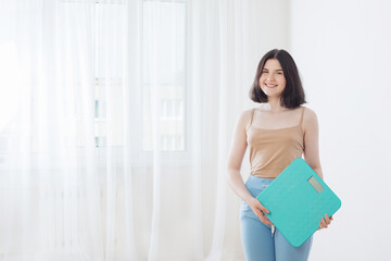 smile teenager girl with scales at home