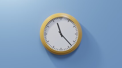 Glossy orange clock on a blue wall at twenty-three past eleven. Time is 11:23 or 23:23