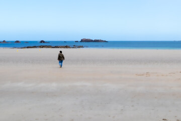 Fototapeta na wymiar woman walking on a sandy beach