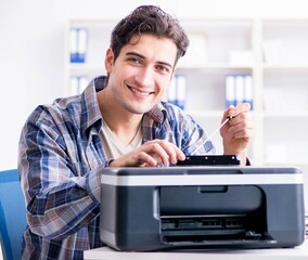 Hardware repairman repairing broken printer fax machine