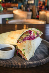 Falafel dosa with sauce.