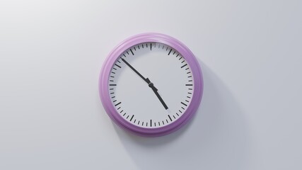 Glossy pink clock on a white wall at fifty-two past four. Time is 04:52 or 16:52