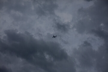 Airplane in the cloudy sky. 
