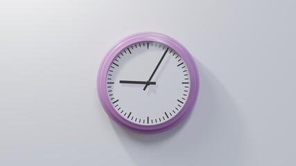 Glossy pink clock on a white wall at five past nine. Time is 09:05 or 21:05