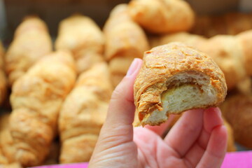 Croissants with condensed milk in hand. Sweet dessert Baking for tea.