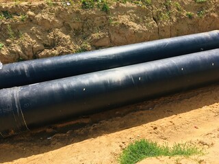 new insulated water pipes in the trench construction site . urban sewerage infrastructure