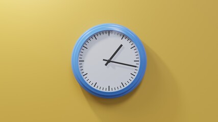Glossy blue clock on a orange wall at seventeen past one. Time is 01:17 or 13:17