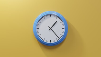 Glossy blue clock on a orange wall at twenty-three past one. Time is 01:23 or 13:23
