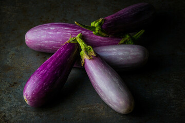 Fairy Tale Eggplants on a dark surface