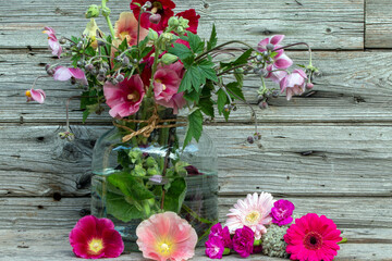 Stockrosen rustikal vor Holzhintergrund als Kartenmotiv