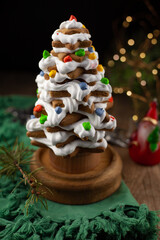 Baked gingerbread christmas tree on wooden background. Close-up