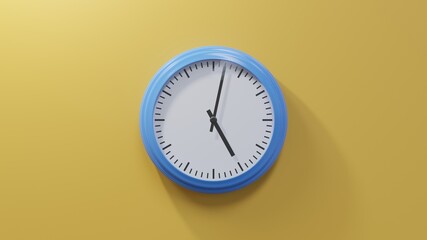 Glossy blue clock on a orange wall at two past five. Time is 05:02 or 17:02