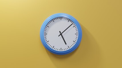 Glossy blue clock on a orange wall at eight past five. Time is 05:08 or 17:08