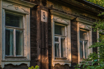 Fototapeta na wymiar Old wooden house. Windows and bushes