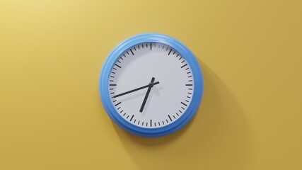 Glossy blue clock on a orange wall at forty-two past six. Time is 06:42 or 18:42