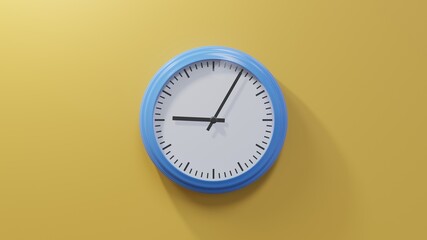 Glossy blue clock on a orange wall at five past nine. Time is 09:05 or 21:05