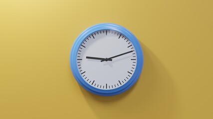 Glossy blue clock on a orange wall at twelve past nine. Time is 09:12 or 21:12