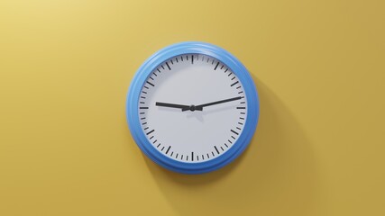 Glossy blue clock on a orange wall at thirteen past nine. Time is 09:13 or 21:13