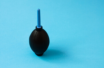Portable kit for cleaning the camera lens close-up on a blue background.