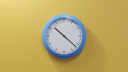 Glossy blue clock on a orange wall at twenty-two past ten. Time is 10:22 or 22:22