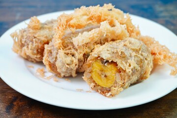 Thai Fried banana fritters with coconut and sesame, Thai desserts  (Kluay Khaek, Kluay Tod)