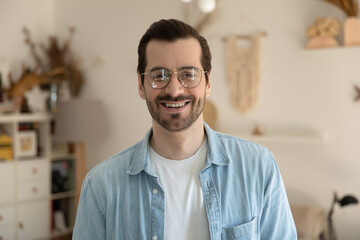 Profile picture of smiling young Caucasian man in glasses show optimism positive and motivation, headshot portrait of happy millennial male client customer in spectacles satisfied with good service