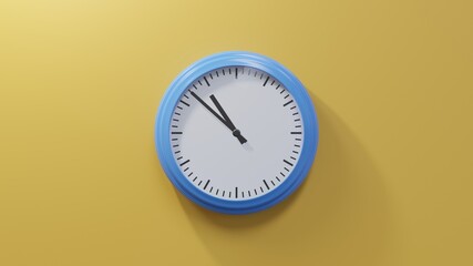 Glossy blue clock on a orange wall at fifty-two past ten. Time is 10:52 or 22:52