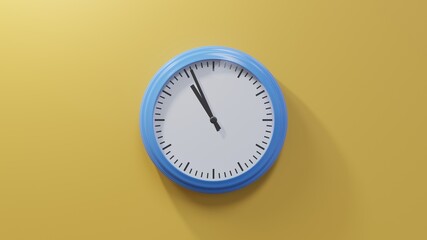 Glossy blue clock on a orange wall at fifty-six past ten. Time is 10:56 or 22:56